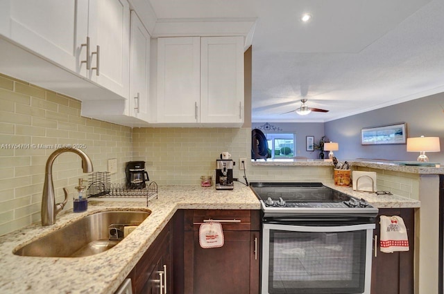 kitchen with a peninsula, stainless steel electric stove, crown molding, white cabinetry, and a sink