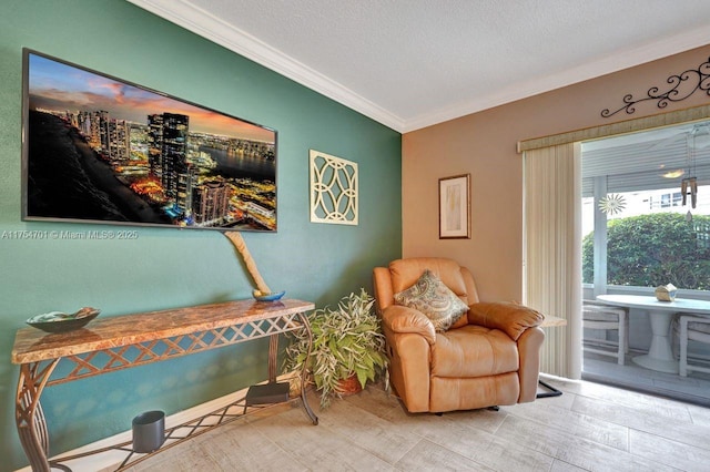 living area featuring ornamental molding, a textured ceiling, and wood finished floors