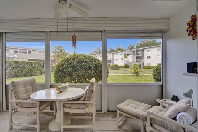 sunroom featuring a ceiling fan