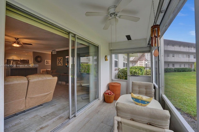 sunroom / solarium with plenty of natural light and ceiling fan