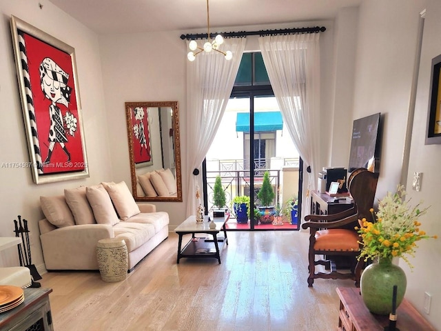 living room with a notable chandelier and wood finished floors