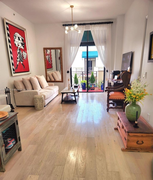 living area with a chandelier and hardwood / wood-style flooring