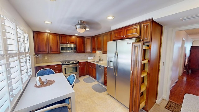 3970 Oaks Clubhouse Dr Unit 307, Pompano Beach, FL 33069 - kitchen featuring appliances with stainless steel finishes, light countertops, a sink, backsplash, and recessed lighting