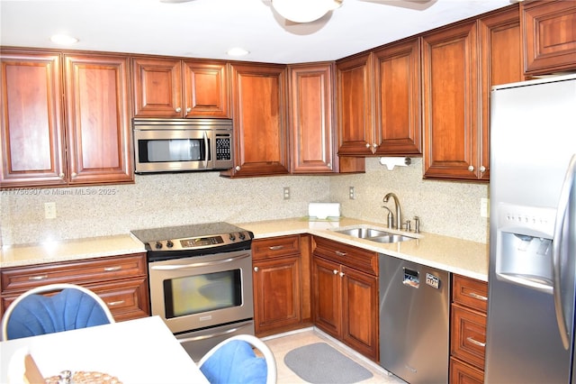 3970 Oaks Clubhouse Dr Unit 307, Pompano Beach, FL 33069 - kitchen with stainless steel appliances, a sink, backsplash, brown cabinets, and recessed lighting