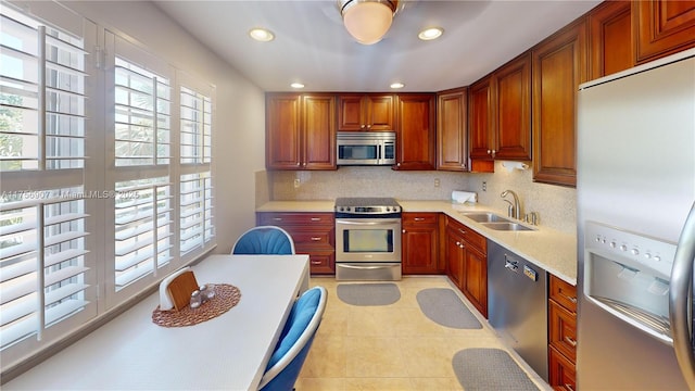 3970 Oaks Clubhouse Dr Unit 307, Pompano Beach, FL 33069 - kitchen featuring appliances with stainless steel finishes, a sink, healthy amount of natural light, decorative backsplash, and recessed lighting