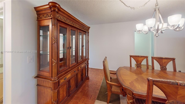 3970 Oaks Clubhouse Dr Unit 307, Pompano Beach, FL 33069 - dining space with a chandelier and a textured ceiling