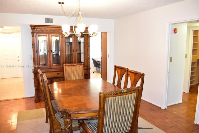 3970 Oaks Clubhouse Dr Unit 307, Pompano Beach, FL 33069 - dining area featuring a chandelier and baseboards