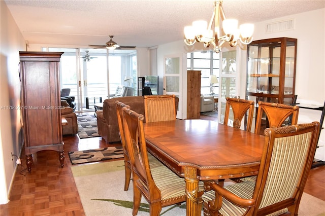 3970 Oaks Clubhouse Dr Unit 307, Pompano Beach, FL 33069 - dining room featuring ceiling fan, a chandelier, a textured ceiling, and expansive windows