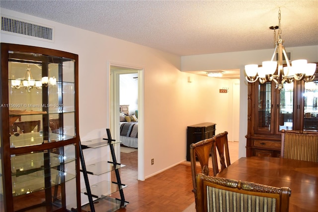 3970 Oaks Clubhouse Dr Unit 307, Pompano Beach, FL 33069 - dining space with a chandelier and a textured ceiling