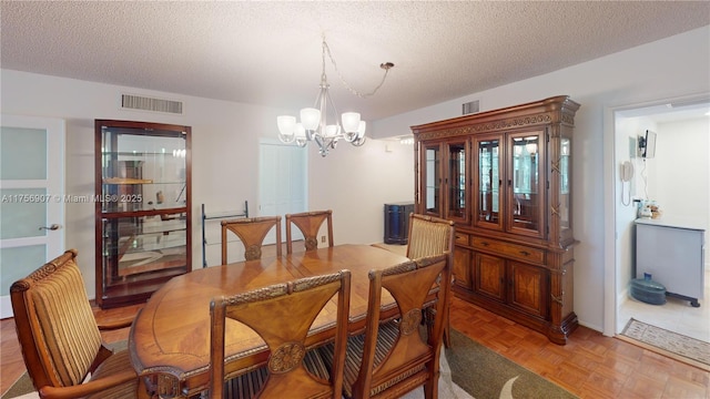 3970 Oaks Clubhouse Dr Unit 307, Pompano Beach, FL 33069 - dining room featuring a chandelier and a textured ceiling