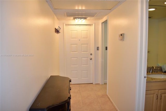 3970 Oaks Clubhouse Dr Unit 307, Pompano Beach, FL 33069 - hallway featuring a sink, light tile patterned floors, and baseboards