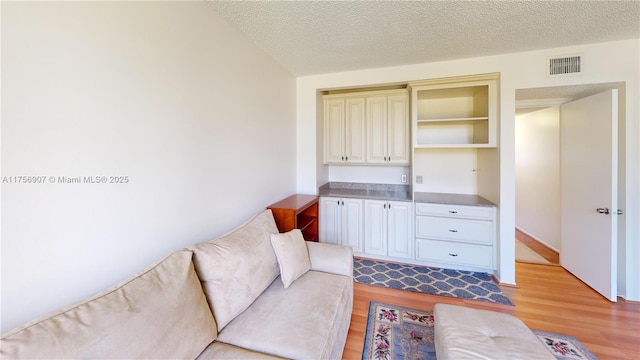 3970 Oaks Clubhouse Dr Unit 307, Pompano Beach, FL 33069 - living area featuring light wood finished floors and a textured ceiling