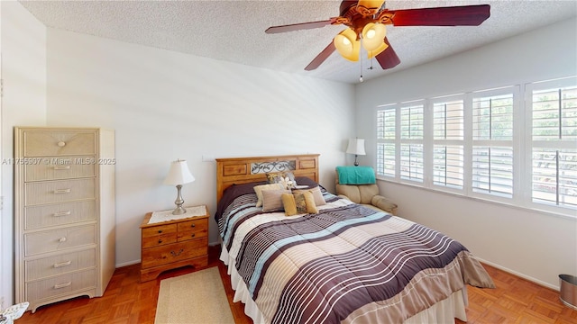 3970 Oaks Clubhouse Dr Unit 307, Pompano Beach, FL 33069 - bedroom featuring multiple windows, a textured ceiling, baseboards, and ceiling fan