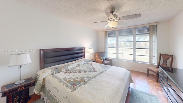 3970 Oaks Clubhouse Dr Unit 307, Pompano Beach, FL 33069 - bedroom with a textured ceiling and a ceiling fan