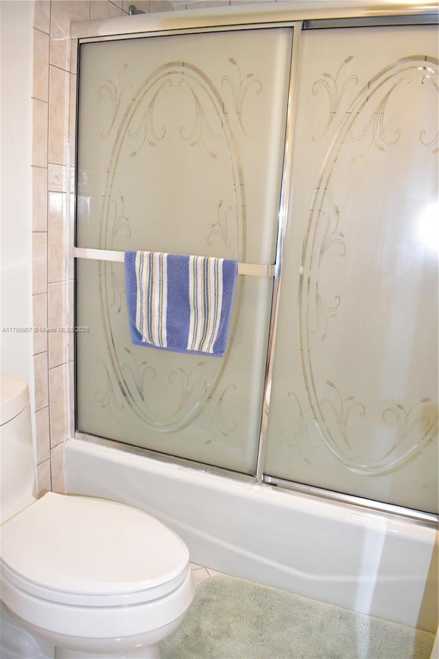 3970 Oaks Clubhouse Dr Unit 307, Pompano Beach, FL 33069 - full bath featuring combined bath / shower with glass door, toilet, and tile patterned floors