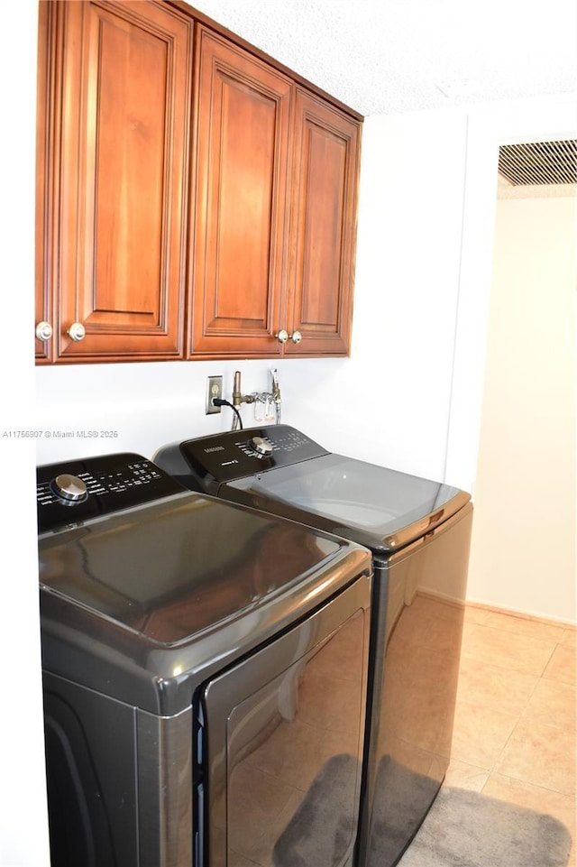 3970 Oaks Clubhouse Dr Unit 307, Pompano Beach, FL 33069 - laundry room with washing machine and dryer, cabinet space, and light tile patterned flooring