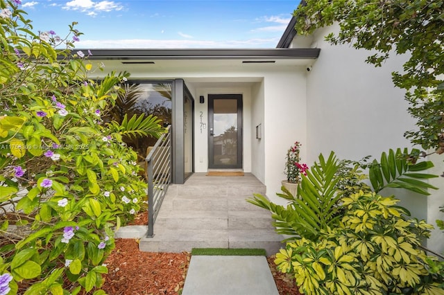 doorway to property with stucco siding