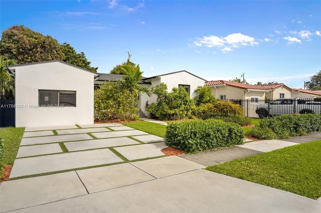 exterior space featuring fence and stucco siding