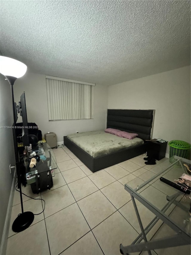 tiled bedroom with a textured ceiling