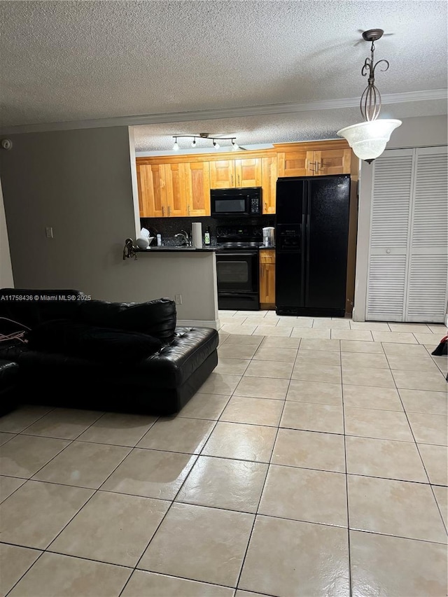 kitchen featuring light tile patterned floors, black appliances, dark countertops, decorative light fixtures, and crown molding