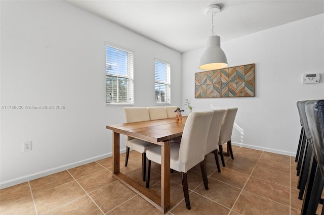 dining room featuring baseboards and tile patterned flooring