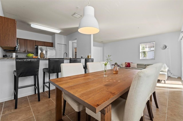 dining area featuring light tile patterned floors and visible vents