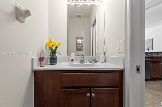 bathroom with tile patterned floors, visible vents, and vanity