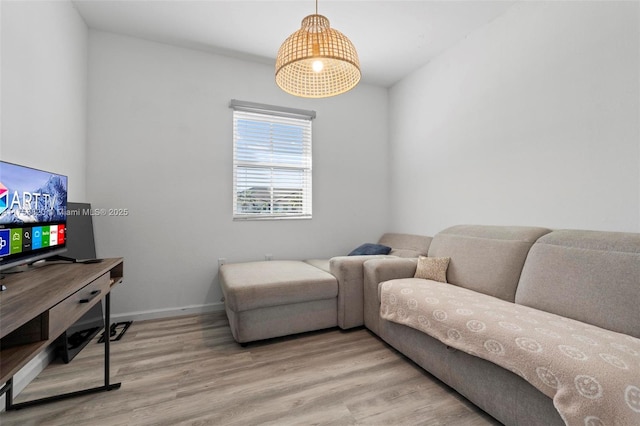 living area featuring light wood-style flooring and baseboards