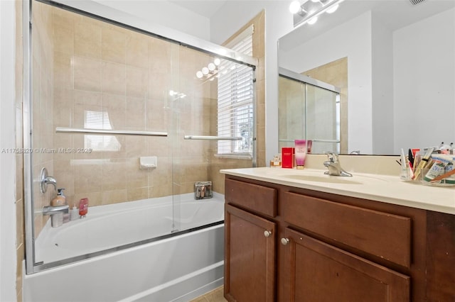 bathroom with vanity and combined bath / shower with glass door