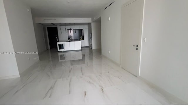 spare room with marble finish floor