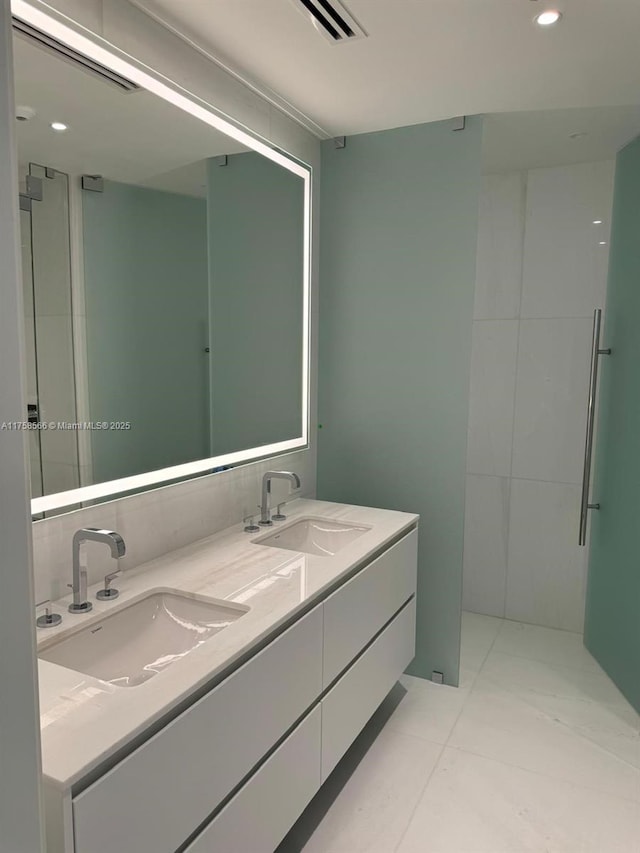 bathroom featuring double vanity, a sink, visible vents, and recessed lighting