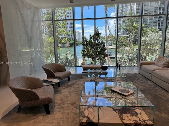 living area featuring a water view and floor to ceiling windows