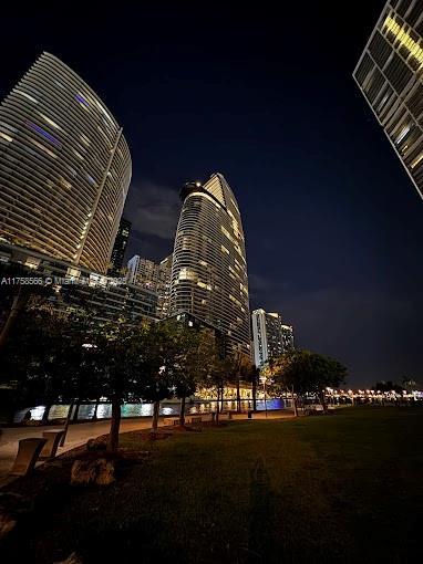 property at night with a view of city lights