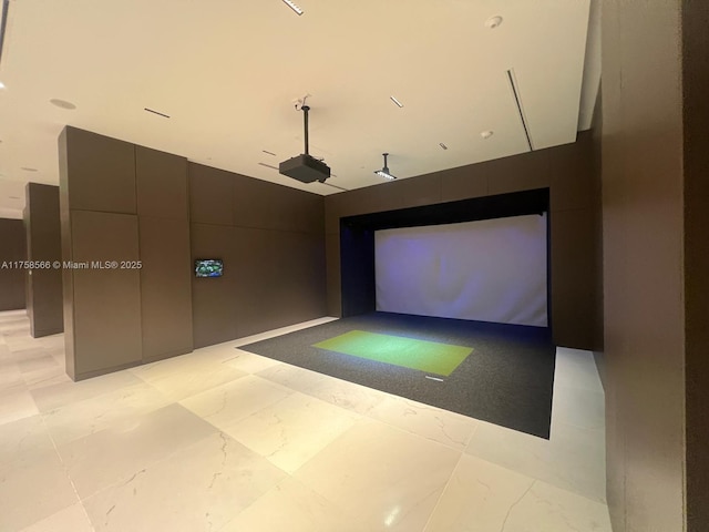 recreation room featuring golf simulator and marble finish floor