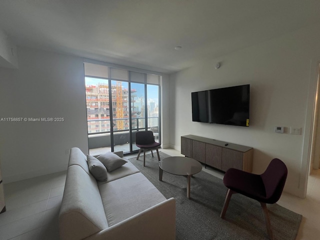 living area featuring floor to ceiling windows and baseboards