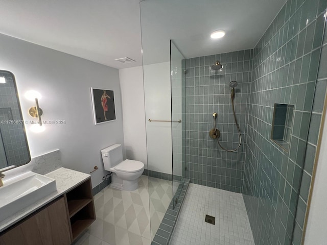 full bathroom with tile patterned flooring, toilet, vanity, visible vents, and a tile shower