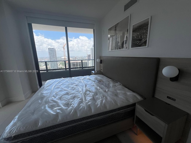 bedroom featuring a city view and visible vents