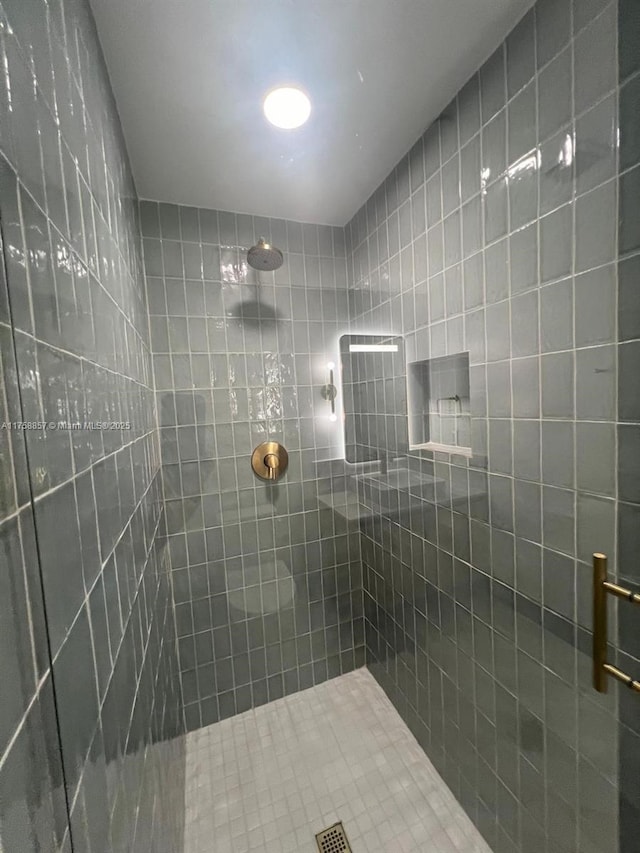 bathroom with a tile shower