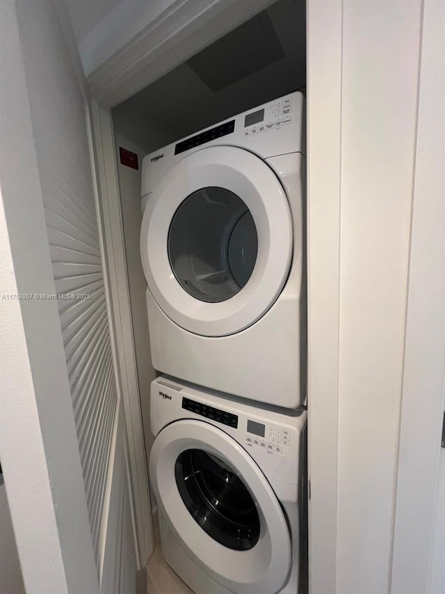 washroom featuring laundry area and stacked washer / dryer