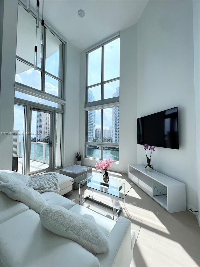 living room with tile patterned flooring and a high ceiling