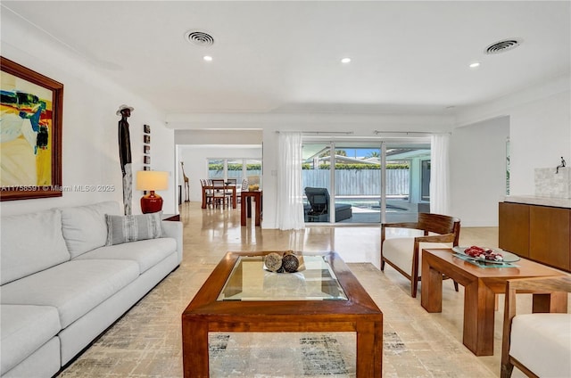 living room featuring recessed lighting and visible vents