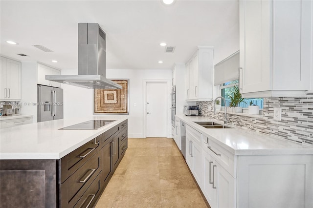 kitchen with island range hood, stainless steel appliances, a kitchen island, a sink, and dark brown cabinets