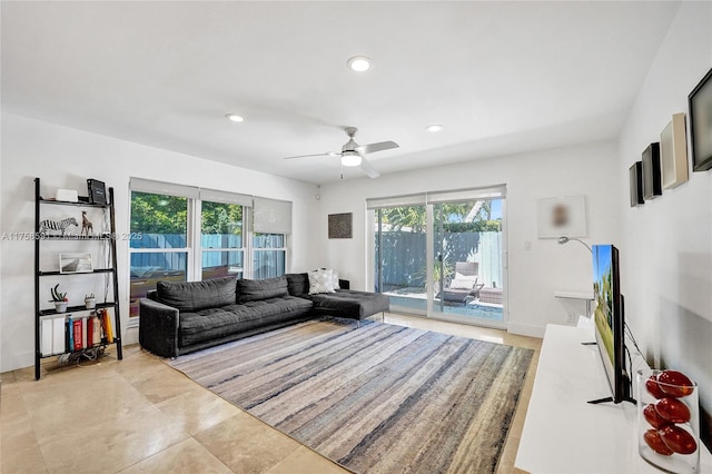 living area with recessed lighting, plenty of natural light, baseboards, and ceiling fan