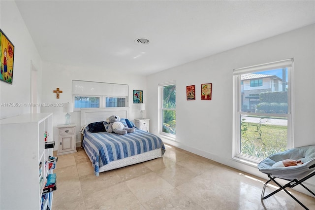 bedroom with visible vents, baseboards, and multiple windows