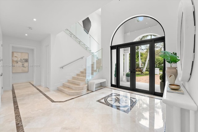 entrance foyer with marble finish floor, recessed lighting, french doors, stairway, and baseboards