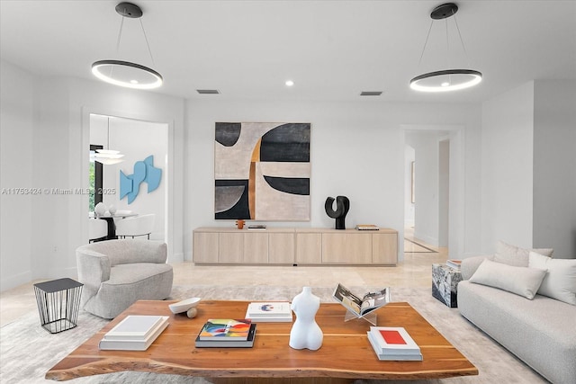 living area featuring baseboards and visible vents