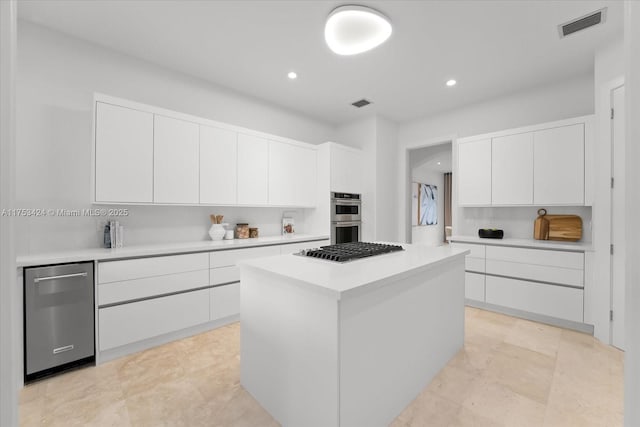 kitchen featuring visible vents, modern cabinets, appliances with stainless steel finishes, and light countertops