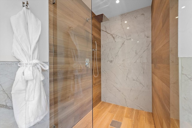 bathroom featuring visible vents, tile walls, and walk in shower