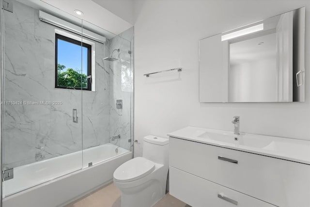 full bath with bath / shower combo with glass door, toilet, and vanity