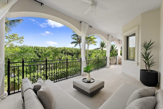 view of patio with a balcony, outdoor lounge area, and ceiling fan